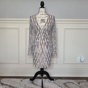 Akira. Sheer sleeves with sequins, pointed studs and a deep v neck